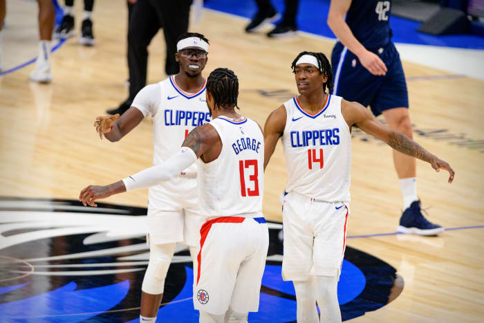 May 28, 2021; Dallas, Texas, USA; LA Clippers guard Paul George (13) and guard Terance Mann (14) celebrate during the second quarter against the Dallas Mavericks in game three in the first round of the 2021 NBA Playoffs at American Airlines Center. Mandatory Credit: Jerome Miron-USA TODAY Sports